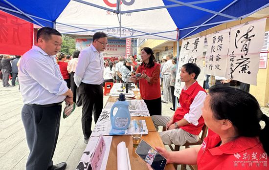 “文化惠民”攤位上，志愿者展示書法作品_副本.jpg